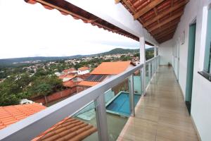 a balcony of a house with a swimming pool at Sobrado Âncora dos sonhos in Pirenópolis