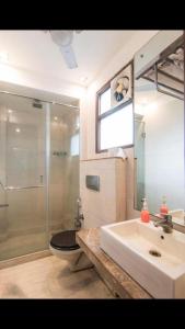 a bathroom with a shower, sink, and tub at Shubham Vilas in New Delhi