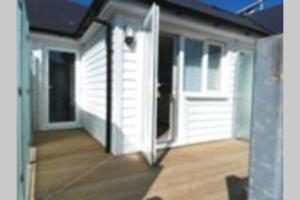 an open door to a house with a porch at SEABREEZE in Kent