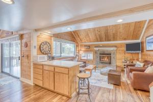 a kitchen and living room with a couch and a fireplace at Pole House 15 - Meredith Lodging in Sunriver