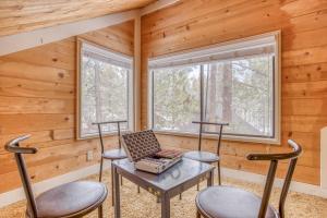 a room with two chairs and a table and two windows at Pole House 15 - Meredith Lodging in Sunriver