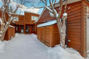 a wooden building with snow on the ground at St John C in Jackson