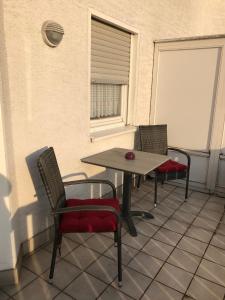 a table and chairs on a balcony with a window at FeWo-Wieseck in Gießen