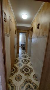 a hallway with a tile floor in a house at Апартаменты возле Зоопарка in Kaliningrad