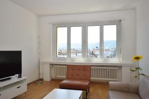 a living room with a couch and two windows at PABS Résidences - Mühlebachstrasse 30 (55) in Zurich