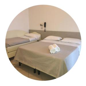 Posteľ alebo postele v izbe v ubytovaní Hotel Amedea