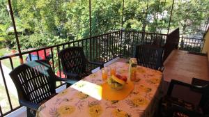 a table with a bowl of fruit on a balcony at Apartments Trupec in Malinska +28 photos