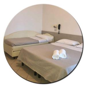 Posteľ alebo postele v izbe v ubytovaní Hotel Amedea