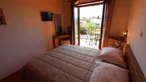 una camera da letto con un letto e vista su un balcone di Apartments and Rooms Jelka a Malinska