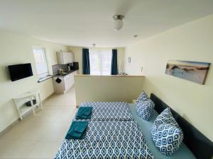 a bedroom with a bed with blue and white sheets at Pension Edelstein in Ostseebad Sellin