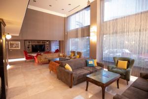 a large living room with couches and chairs at Sogut Hotel Old City in Istanbul