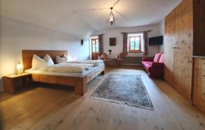 a bedroom with a bed and a living room at Gästehaus Högerhof in Hopfgarten im Brixental