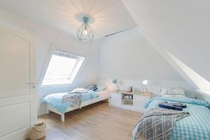 Postel nebo postele na pokoji v ubytování Haus am Strand Ferienwohnung Haus am Strand 3