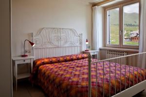 a bedroom with a bed and a window at Residence Redivalle in Passo del Tonale