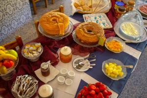 a table with cakes and other food on it at Beira Dão - Turismo Rural in Tondela +10 photos