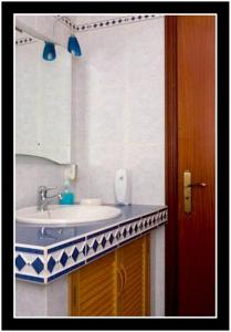 a bathroom with a sink and a mirror at One bedroom appartement with sea view terrace and wifi at Lajes Do Pico in Lajes do Pico