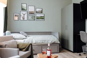 a bedroom with a bed with pictures on the wall at Apartment an der Altstadt (#6) in Hameln