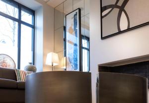 a living room with a couch and a fireplace at Montfleuri in Paris