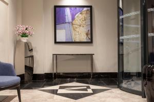 a living room with a fireplace and a picture on the wall at Montfleuri in Paris