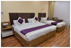 Postel nebo postele na pokoji v ubytování Hotel Siddharsh Heritage