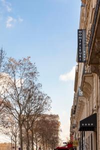a street in a city with buildings and trees at Montfleuri in Paris