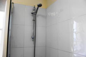 a shower with a shower head in a bathroom at The Olive Branch in Ilfracombe
