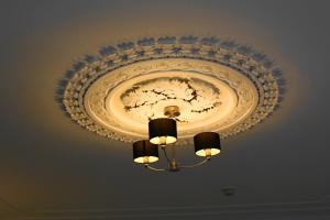 a chandelier hanging from a ceiling with a plate on it at The Olive Branch in Ilfracombe