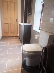 a bathroom with a toilet and a sink at Three Peaks View Cottage in Wigglesworth +20 photos