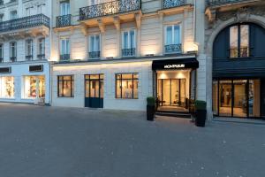 a facade of a building with windows and a store at Montfleuri in Paris