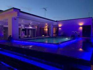 a house with a swimming pool with blue lights at Liberdada Suites in Wanica