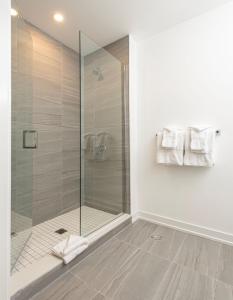 a bathroom with a shower with a glass door at Muskoka Bay Resort in Gravenhurst