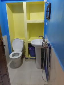 a bathroom with a toilet and a sink at Chez Belkacem in Merzouga