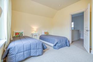 a bedroom with two beds with blue comforters at Georgia Peach - Meredith Lodging in Bend +25 photos