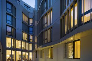 a building with many windows and lights on at The Passage - Urban & Lifestyle Hotel in Basel