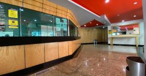 a lobby of a building with a counter in the middle at Hotel Lord in Mexico City