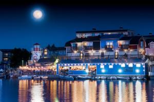 a large building with boats in the water at night at Old Harbor Inn in South Haven