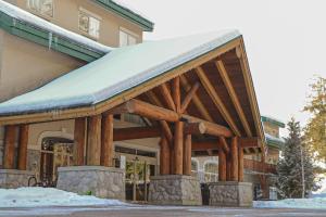 a timber building with a snow covered roof at Coast Hillcrest Hotel in Revelstoke