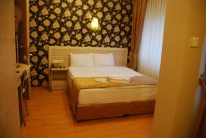 Postel nebo postele na pokoji v ubytování Mini Hotel