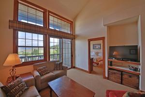 a living room with a couch and a tv at Kicking Horse Lodges 4-302 in Granby