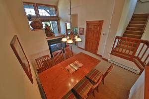 a dining room with a wooden table and chairs at Kicking Horse Lodges 4-302 in Granby