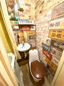 a bathroom with a toilet and a sink with signs at В центрі біля Ратуші вулиця Площа Ринок 11 in Lviv