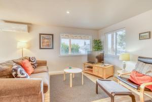 a living room with a couch and a tv at Sandy Feet in Nehalem