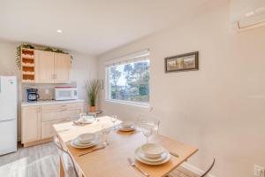 a kitchen with a table and chairs and a refrigerator at Sandy Feet in Nehalem