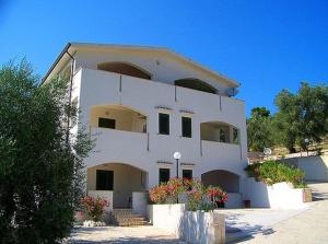 a large white building with flowers in front of it at Villa Rinaldi apartment in Vieste