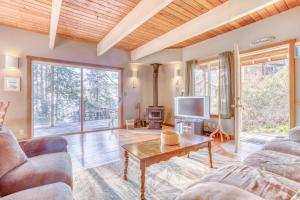 a living room with two couches and a table at 38445 Reed - Meredith Lodging in Manzanita