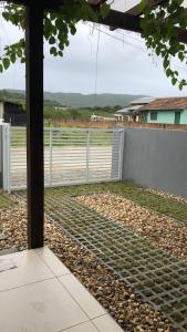 a view of a fence from the inside of a house at Mini Casa na praia! in Bombinhas