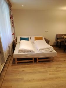 a bed with two pillows on it in a room at Haus Partoll in Kappl