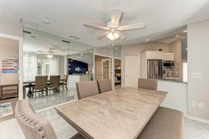 a dining room with a table and a ceiling fan at Modern Home with Screened-In Pool 4 Mi to the Beach in Venice