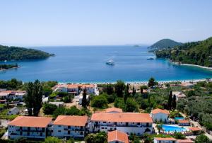 a view of a town and a body of water at Afroditi in Panormos Skopelos