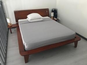 a bed in a bedroom with two night stands at appart coeur de rhum in Pointe-à-Pitre